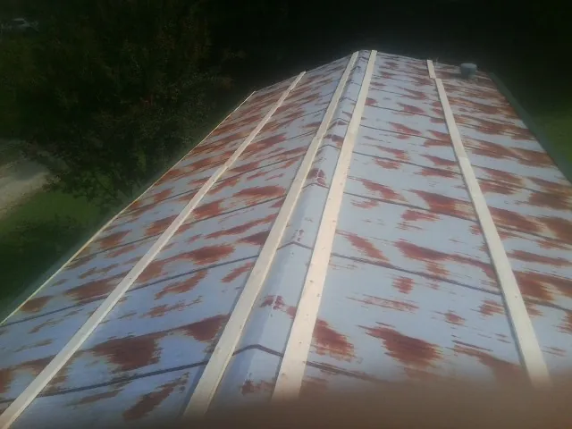 Rusted metal roof panels with new wood purlins before replacement — Storm Damage Roof Repair in Poughquag by Roofing Brothers